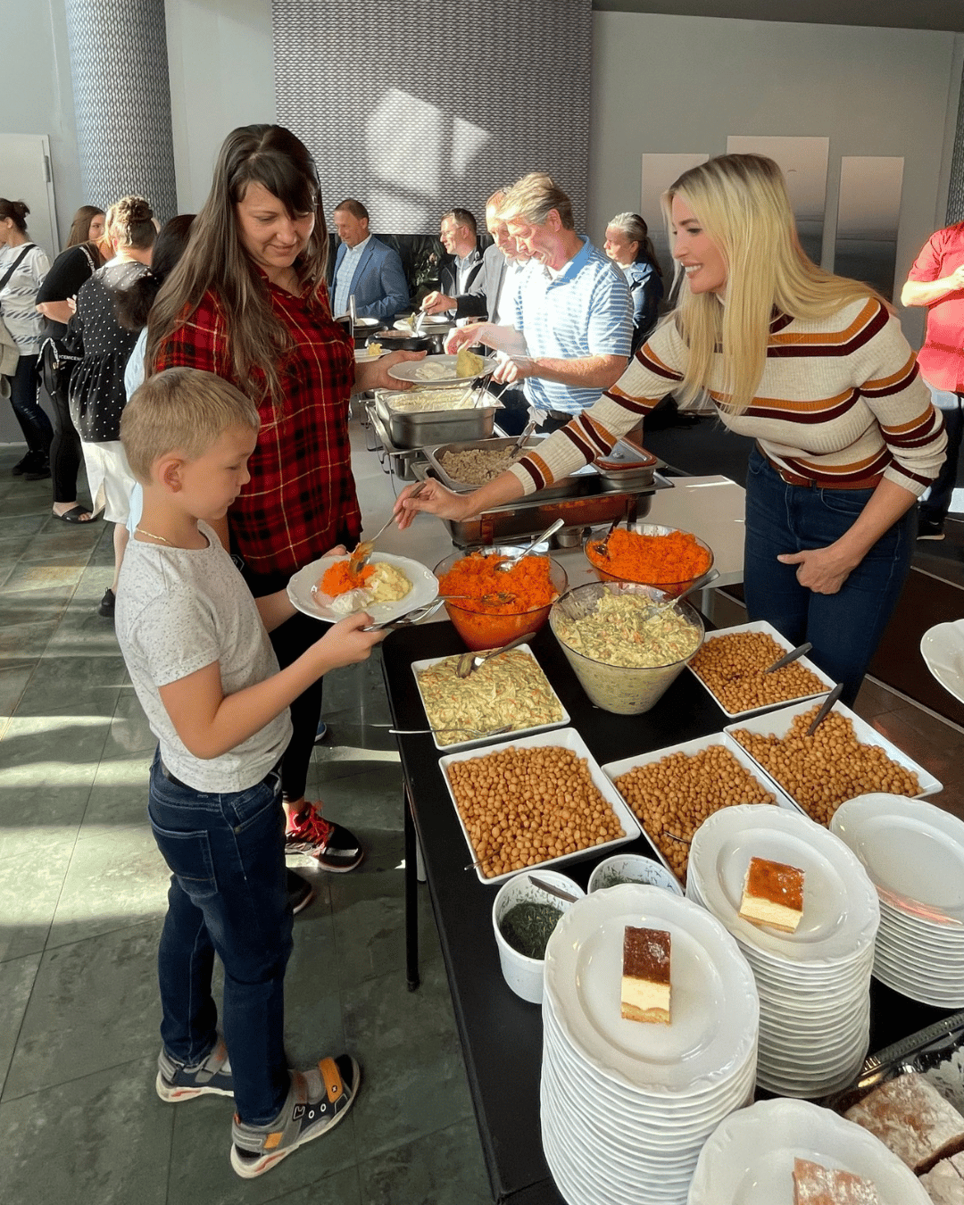 Ivanka Trump serving a little boy food.