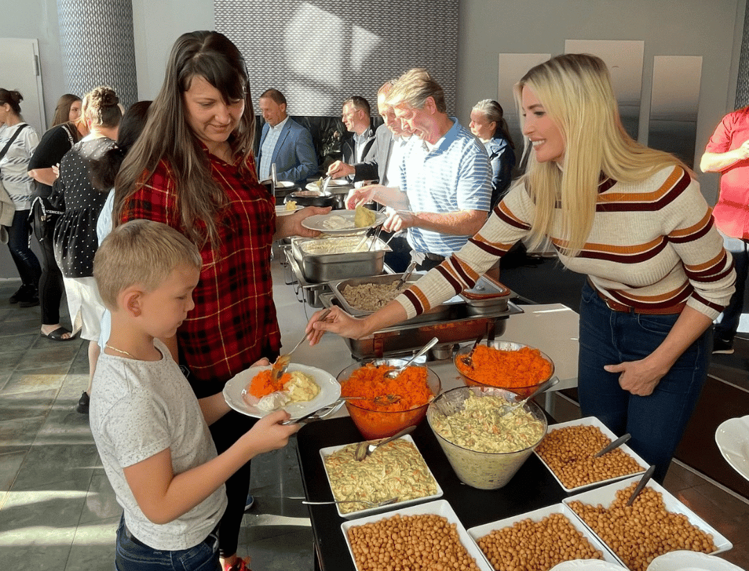 Ivanka Trump serving a little boy food.