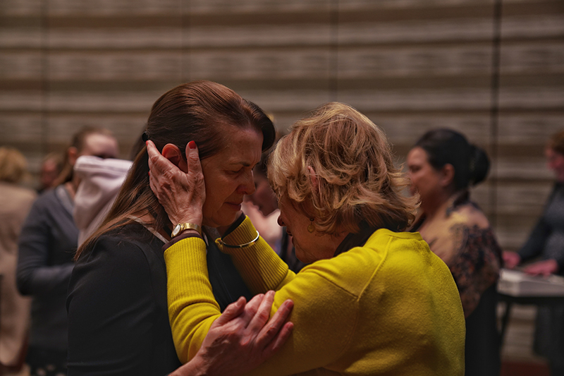 Women praying together.