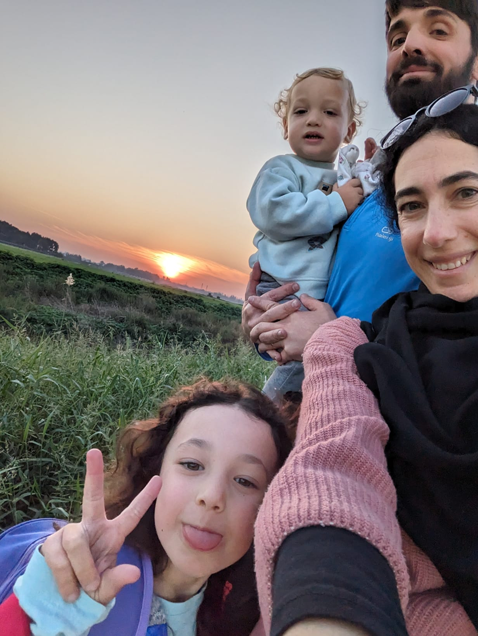 The Golovan family smiling at sunset in Ein HaBesor after returning home following October 7 attacks.